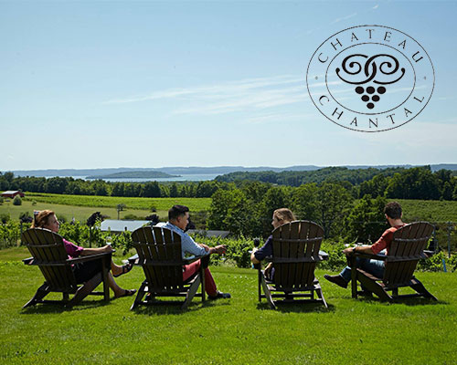 Group of people enjoying a summer day at the Chateau Chantal Winery in Traverse City.